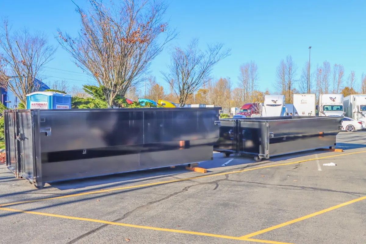 Professional dumpster rental service with roll-off container on residential driveway in Aliso Viejo